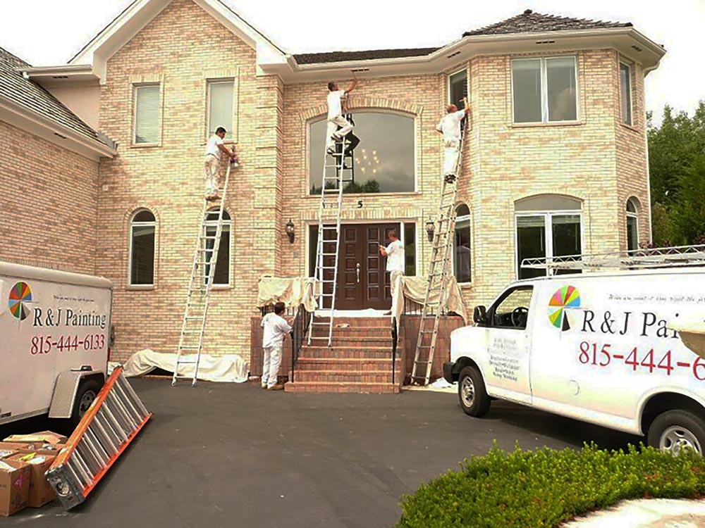 painting crew painting exterior of a residential house