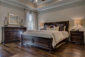 Bedroom with neutral painted walls and wood flooring