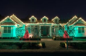 An R&J Painting team member expertly arranging Christmas lights, illustrating why we’re the best choice for professional installation near you. Christmas Lights Installation Near Me.