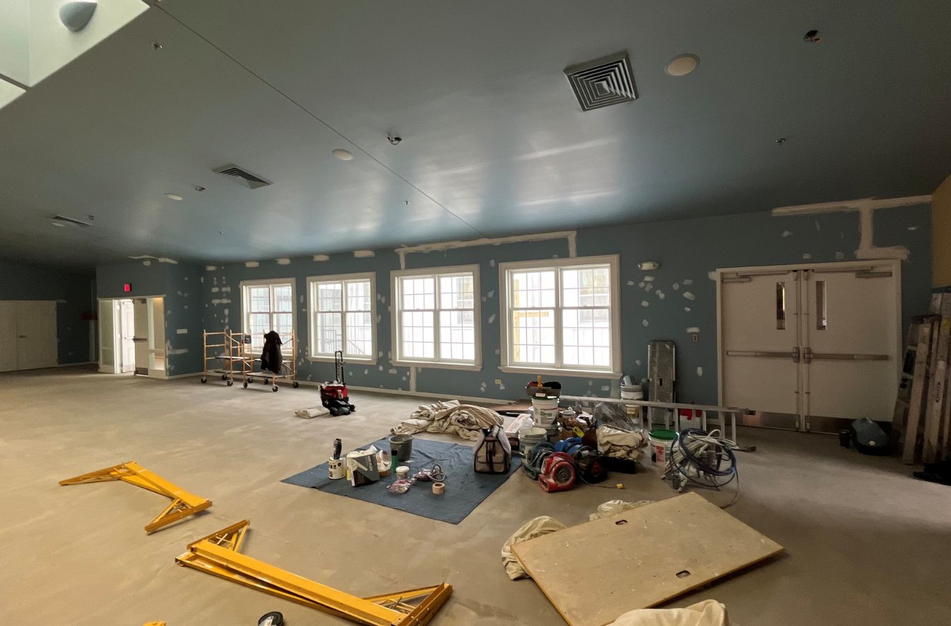 A R&J Painting professional collaborating with a client in Arlington Heights, IL, explaining painting strategies and premium service options. Commercial Painting Contractor near me.