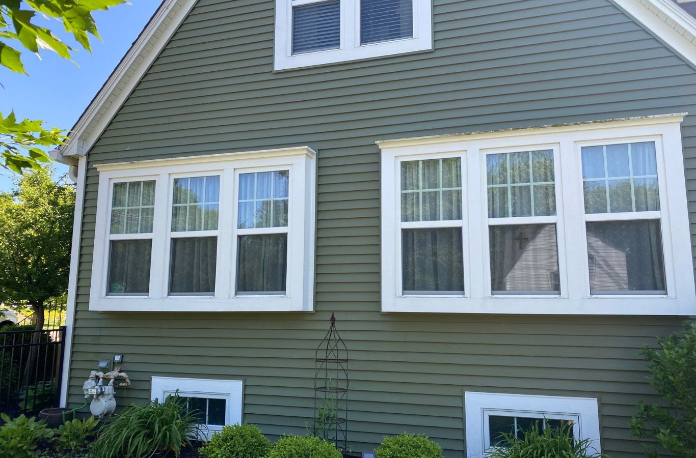 A skilled R&J Painting crew member painting a home exterior in Wauconda, IL, showing quality workmanship and reliable service.