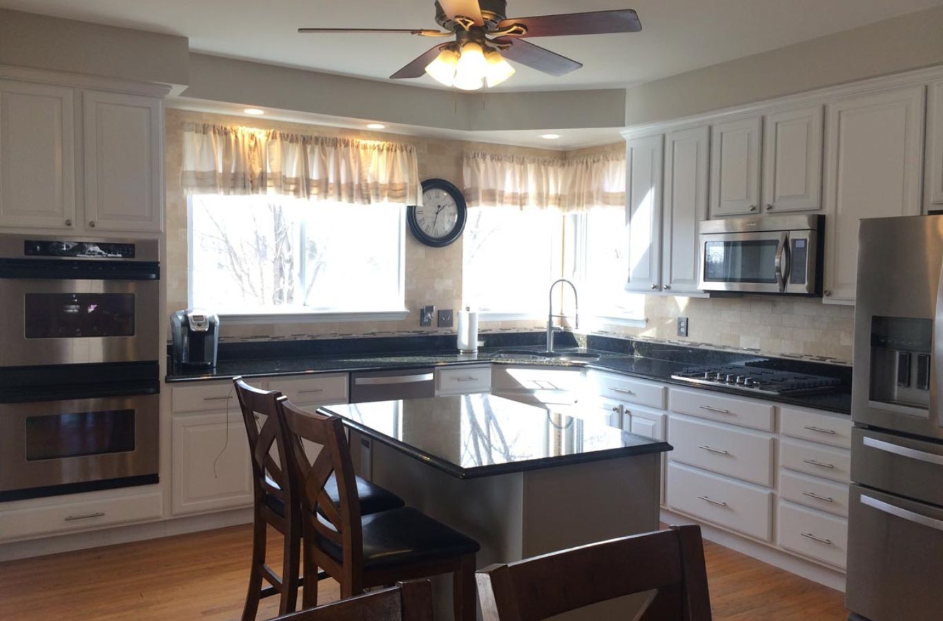 10 R&J Painting specialist performing Cabinet Painting in Crystal Lake, IL using spray equipment for smooth finishes.