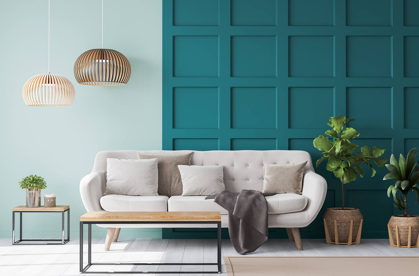 hospitality-3 A stylish living room with a white sofa, wooden coffee table, and teal accent wall. Two pendant lights hang above, and greenery adds a fresh touch.